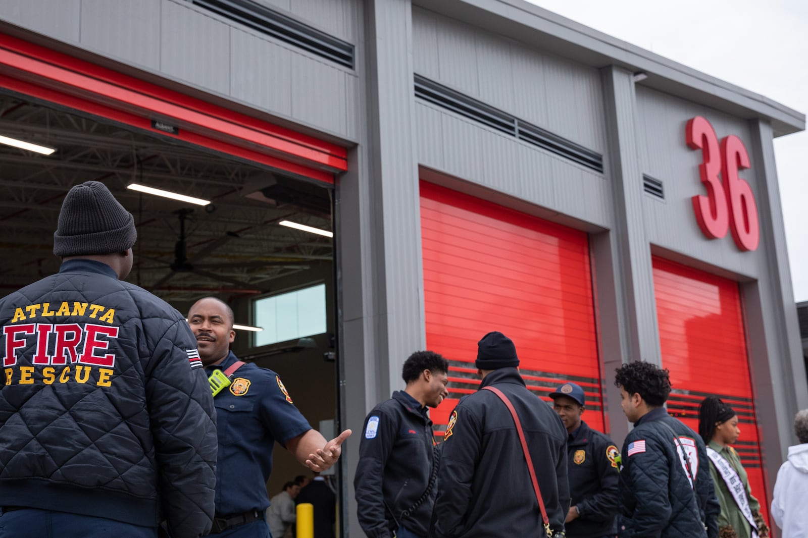 Members of the Atlanta Fire Rescue Department gather outside of Fire Station 36 on Feb. 9, 2024. The new station will replace the old facility just down the road that was shuttered due to equipment issues. Riley Bunch/riley.bunch@ajc.com