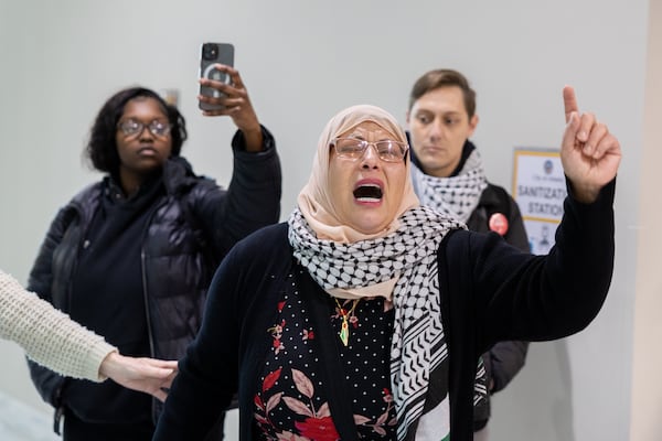 Jawahir Sharwany (center) reacts as police block family members and activists protesting the death of Cornelius Taylor, an unhoused man killed when the city cleared an encampment last week, at City Hall in Atlanta on Thursday, January 23, 2025. The group wanted to deliver a letter to the mayor. (Arvin Temkar / AJC)