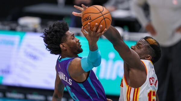 Charlotte Hornets forward Jalen McDaniels (left) drives to the basket against Atlanta Hawks center Clint Capela during the third quarter Sunday, April 11, 2021, in Charlotte, N.C. (Nell Redmond/AP)