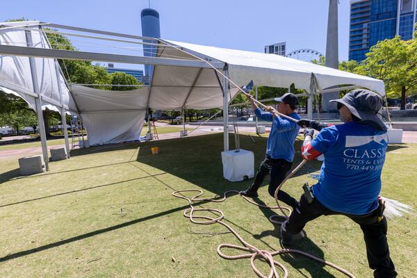 Classic Tents and Events workers erect tents Tuesday for the Atlanta City Games that will be held in  Centennial Olympic Park on Saturday, May 6.  (Steve Schaefer/steve.schaefer@ajc.com)