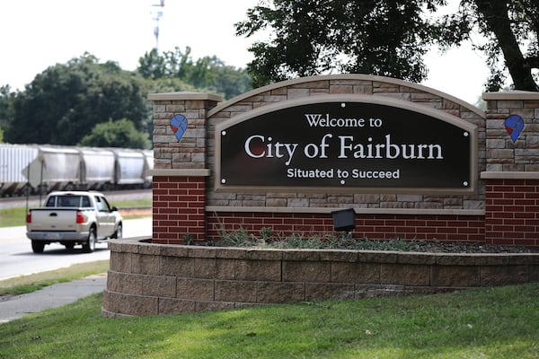 A motorist passes by the Welcome to City of Fairburn sign at the edge of town, with the city’s motto of ‘Situated to Succeed’. CURTIS COMPTON/CCOMPTON@AJC.COM