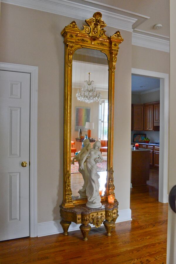 "My favorite piece of furniture is an 1880s 10-foot high Renaissance Revival pier mirror, purchased at an estate sale in Stone Mountain," says homeowner Pedro Ayestaran Diaz. "I love the majesty of its size." At the base of the mirror is a 1900s art nouveau statue made of Carrara marble, signed A. Batacchi/Florence, found at Fontaine's Auction Gallery in Massachusetts. Text by Lori Johnston and Keith Still/Fast Copy News Service. (Christopher Oquendo Photography/www.ophotography.com)