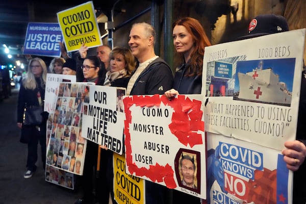 Demonstrators, including Lindsey Boylan, second from right, a former aide to former Gov. Andrew Cuomo, who accused him of an unwanted kiss, stand outside a fundraiser in New York, Tuesday, March 4, 2025. (AP Photo/Richard Drew)