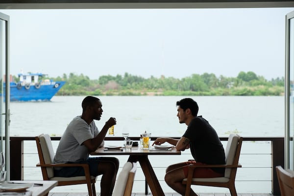 In "Monsoon," Kit (Henry Golding, right) and Lewis (Parker Sawyers) bond over being fish out of water in Vietnam. 
Courtesy of Dat Vu