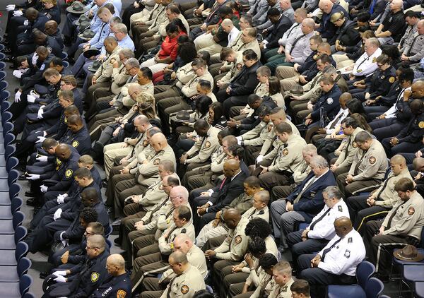 December 14, 2016, AMERICUS: Hundreds of police officers bow in prayer during the funeral service of Georgia Southwestern State University campus police officer Jody Smith at the university on Wednesday, Dec. 14, 2016, in Americus. Officer Smith and Americus police officer Nicholas Ryan Smarr, best friends, were killed responding to a domestic dispute.     Curtis Compton/ccompton@ajc.com