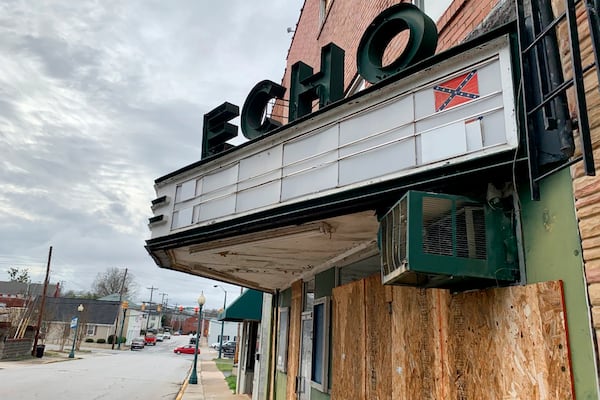 In this Monday, Jan. 13, 2020 photo, reminders of "The Redneck Shop" are still on display on the Echo Theater's marquee, in Laurens, S.C. The building was used as a meeting place for members of the Ku Klux Klan. (AP Photo/Sarah Blake Morgan)