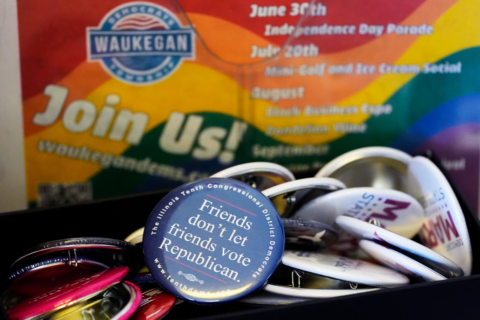 Pins are displayed on the table at the Waukegan Township Democrats office in Waukegan, Ill., Monday, Sept. 16, 2024. (AP Photo/Nam Y. Huh)