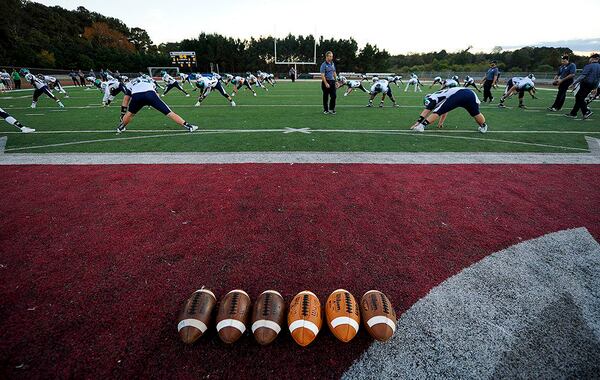 6 footballs and player warmups