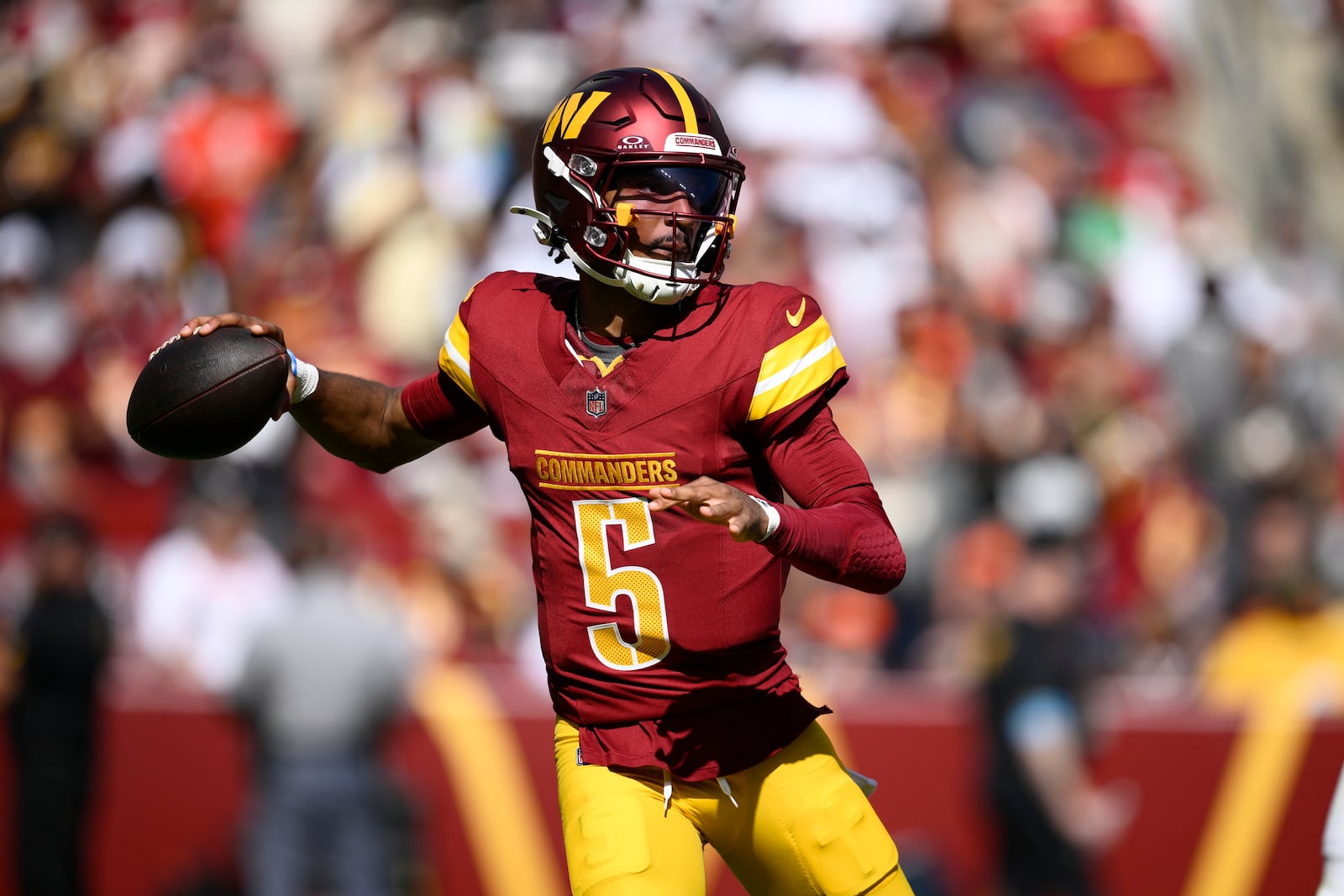 Washington Commanders quarterback Jayden Daniels (5) looks to pass against the Cleveland Browns during the first half of an NFL football game in Landover, Md., Sunday, Oct. 6, 2024. (AP Photo/Nick Wass)