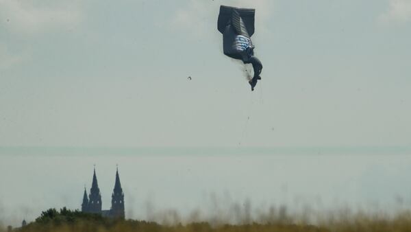 A blimp crashes during the first round of the U.S. Open golf tournament Thursday, June 15, 2017, near Erin Hills in Erin, Wis. An official with the company operating the advertising blimp at the U.S. Open said the pilot is "OK" after the craft crashed but that he was taken to a hospital.