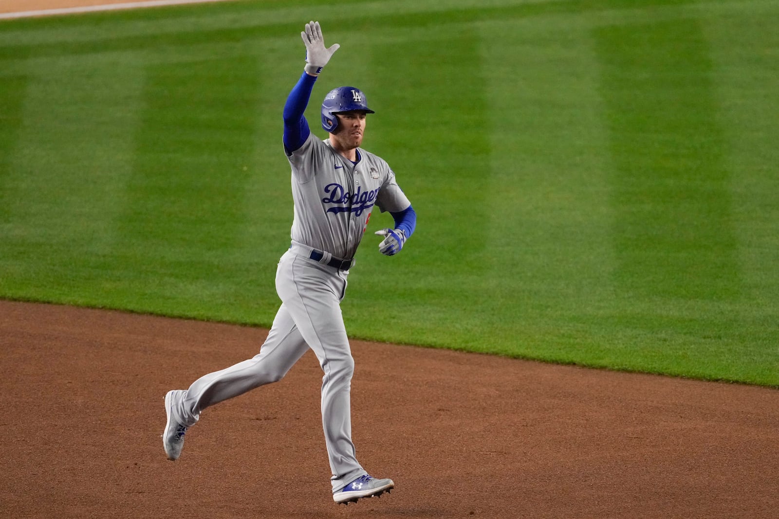 Los Angeles Dodgers' Freddie Freeman celebrates a two-run home run against the New York Yankees during the first inning in Game 4 of the baseball World Series, Tuesday, Oct. 29, 2024, in New York. (AP Photo/Frank Franklin II)