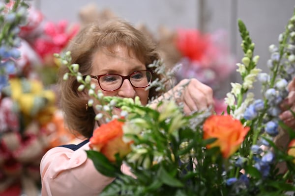 Cheryle McCrary, helps her daughter and store owner Hope Jones (not pictured), working on floral arrangements for the Carter’s family at Plains Sweet Stems, Thursday, Feb. 23, 2023, in Plains, GA. (Hyosub Shin / Hyosub.Shin@ajc.com)