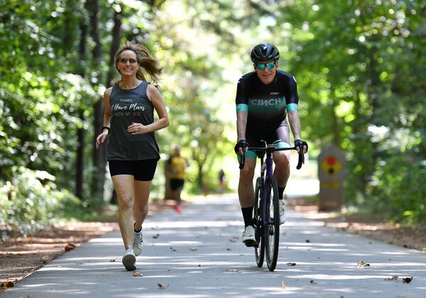 Kevin Avery and Taylor Scott, hosts of "The Kevin & Taylor Show,” exercise on the Silver Comet trail in Smyrna recently. Avery is an avid cyclist and Scott is a big runner. Hyosub Shin / Hyosub.Shin@ajc.com