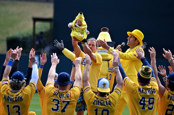 Savannah Bananas owner Jesse Cole and team members welcome a Banana Baby before the game. (Hyosub Shin / Hyosub.Shin@ajc.com)