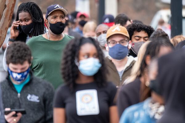 In this file photo from December 2021, Craig Geter, left, waits in line for COVID testing at the Fulton County Center for Health and Rehabilitation Ben Gray for the Atlanta Journal-Constitution