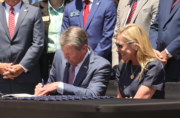 Gov. Brian Kemp signs Senate Bill 233, which will give parents $6,500 that can be used for private school tuition or home-schooling if they take their child out of a low-performing public school. (Natrice Miller/ AJC)