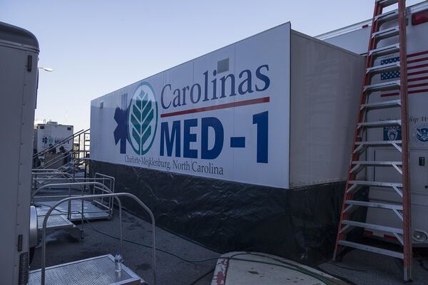 The exterior of Carolinas MED-1 (right), a mobile medical facility located outside of the Marcus trauma and emergency room at Grady Memorial Hospital in Atlanta. (ALYSSA POINTER/ALYSSA.POINTER@AJC.COM)