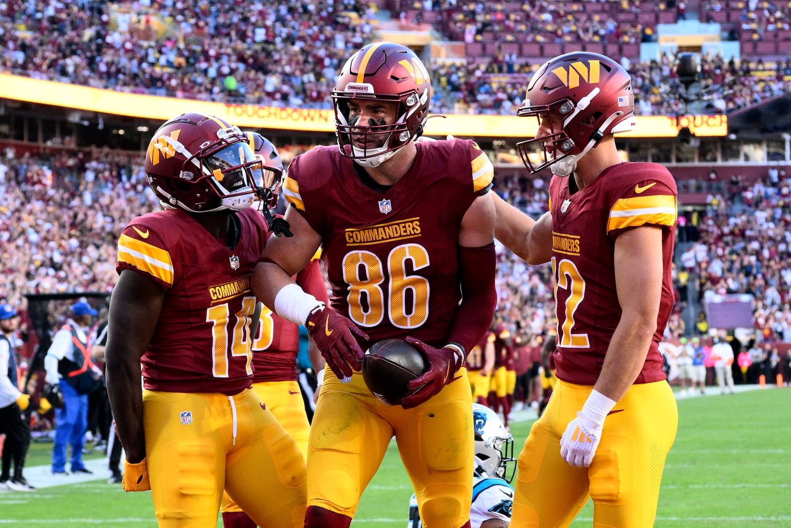 Washington Commanders tight end Zach Ertz (86) celebrates with teammates after catching a 12-yard touchdown pass during the first half of an NFL football game against the Carolina Panthers, Sunday, Oct. 20, 2024, in Landover, Md. (AP Photo/Nick Wass)