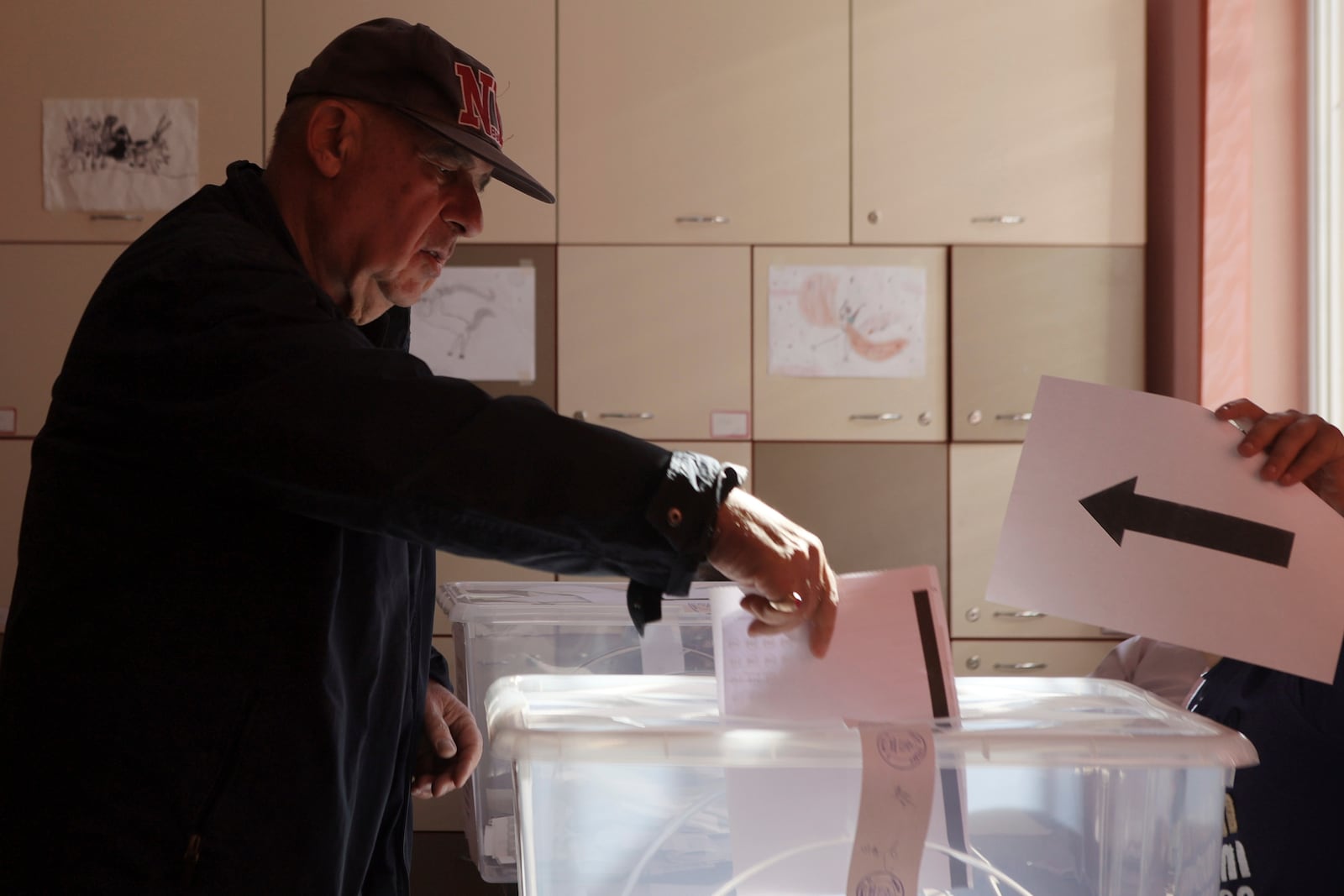 A man casts his ballot at a polling station during the general elections in Sofia, Sunday, Oct. 27, 2024. (AP Photo/Valentina Petrova)