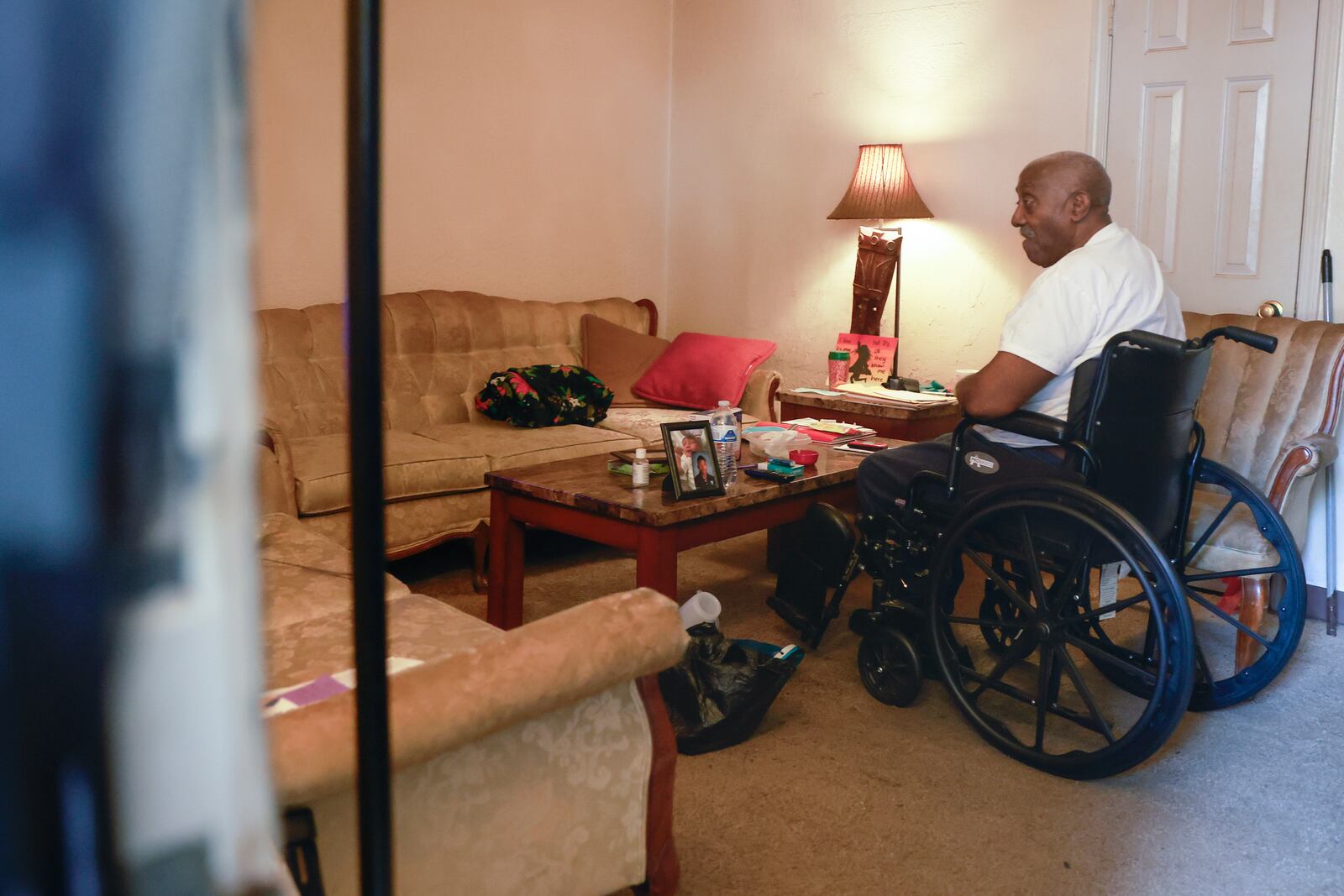 William Patterson tells inspectors from the city's Safe and Secure Housing program in July how mold is growing in the living room of his Woodland Heights apartment. City officials hope repeated enforcement by the program will pressure apartment complex owners to make repairs or sell to more responsible owners. (Natrice Miller/natrice.miller@ajc.com)