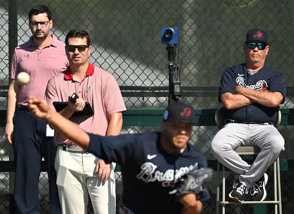 Braves manager Brian Snitker (right) watches as  relief pitcher Joe Jimenez throws a pitch during Braves spring training at CoolToday Park, Friday, Feb. 17, 2023, in North Port, Fla.. (Hyosub Shin / Hyosub.Shin@ajc.com)