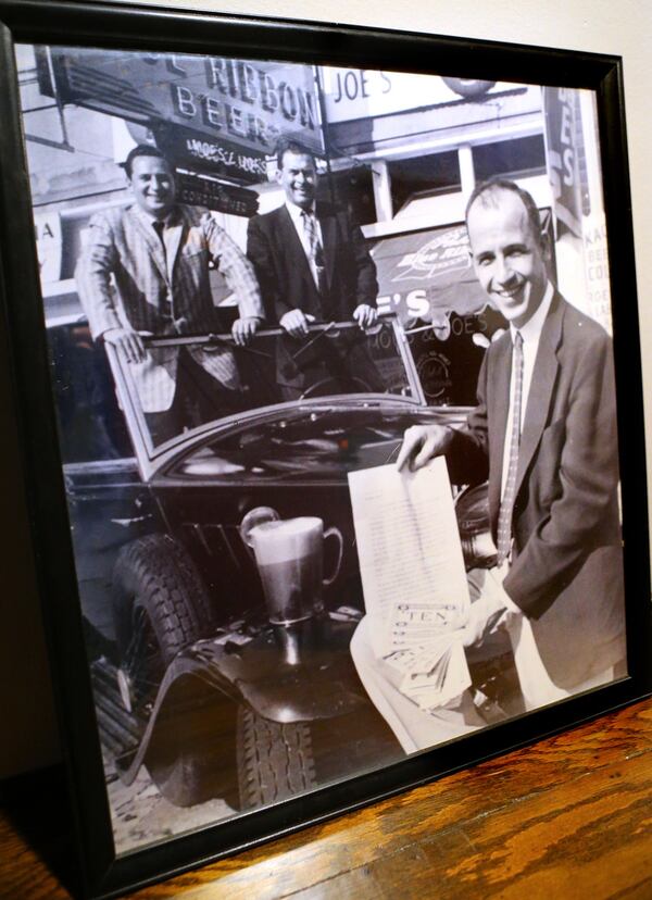 An infamous photograph of original owners Moe (left) and Joe Krinsky trading the promise of pitchers of beer for Bob Harvey's Rolls Royce. Photo: Curtis Compton / AJC