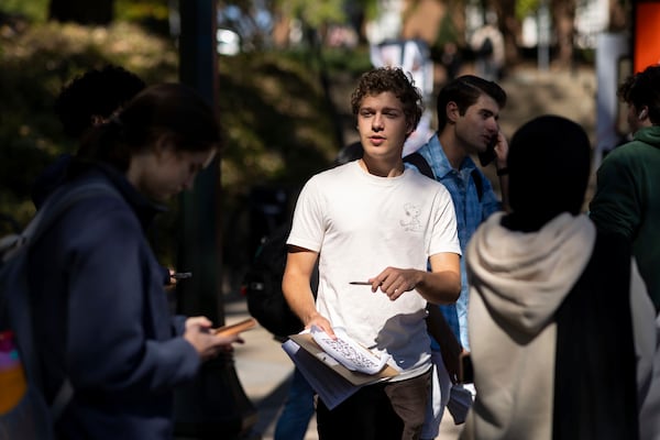 Will Pinto polls students on their voter registration status at the University of Virginia in Charlottesville, Va., Friday, Oct. 11, 2024. (AP Photo/Ryan M. Kelly)