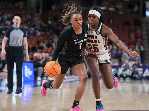 Vanderbilt guard Mikayla Blakes (1) drives oni South Carolina guard Raven Johnson (25) during an NCAA college basketball game in the quarterfinals of the Southeastern Conference tournament, Friday, March 7, 2025, in Greenville, S.C. (AP Photo/David Yeazell)