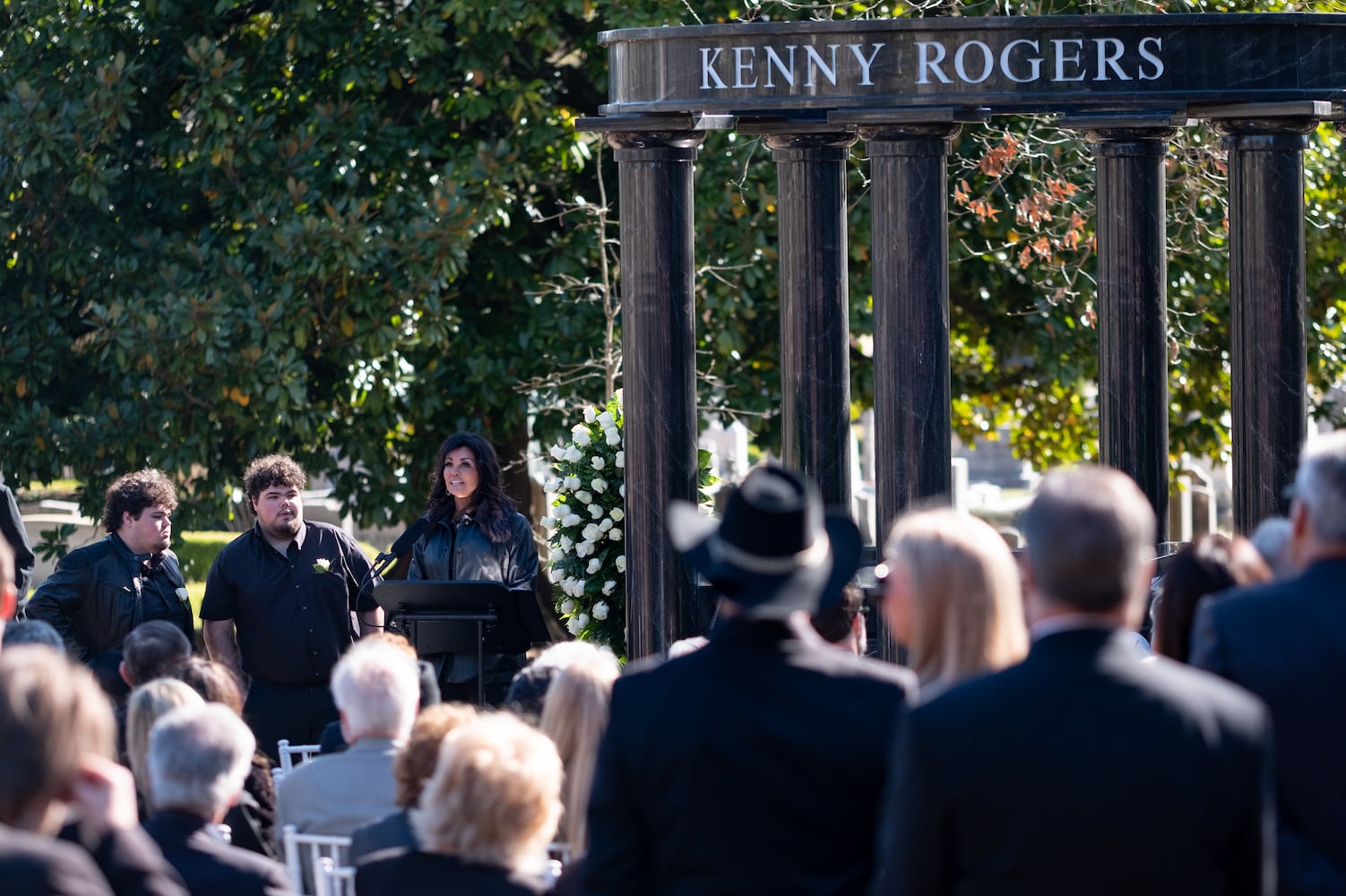 Wanda Rogers, widow of country legend Kenny Rogers, speaks with their twin sons Justin and Jordan by her side during a memorial service at Oakland Cemetery on Sunday, Mar. 20, 2022. Rogers died Mar. 20, 2020, but the memorial service was postponed for two years due to the Covid-19 pandemic.  Ben Gray for the Atlanta Journal-Constitution