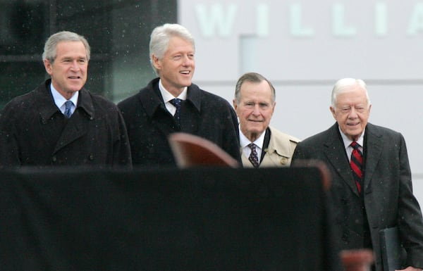 FILE - President George W. Bush, left to right, former President Bill Clinton, former President George H.W. Bush, and former President Jimmy Carter walk from the William J. Clinton Presidential Center to the podium during opening ceremonies in Little Rock, Ark., Nov. 18, 2004. (AP Photo/Ric Feld, File)