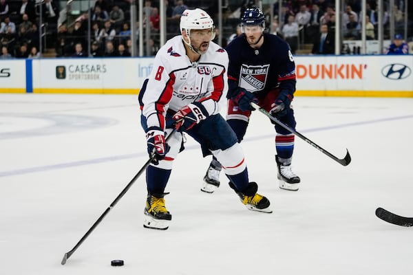 Washington Capitals' Alex Ovechkin (8) drives past New York Rangers' J.T. Miller (8) during the overtime period of an NHL hockey game Wednesday, March 5, 2025, in New York. (AP Photo/Frank Franklin II)