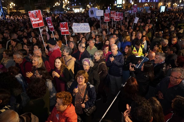 Demonstrators march during a protest a month after devastating floods to demand the resignation of the regional officials who bungled the emergency response in Valencia, Spain, Tuesday, Nov. 30, 2024. (AP Photo/ Alberto Saiz)