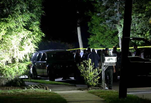 Police investigators look for evidence outside the home of Judge Esther Salas, in North Brunswick, New Jersey, early Monday. A gunman shot her son and husband on Sunday, according to an official with knowledge of the situation. (Yana Paskova/The New York Times)