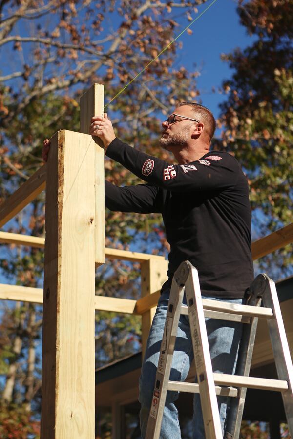 Marine veteran Josh Lear volunteers with the Cherokee County Homeless Veteran Program to build a handicap ramp at the future home of a disabled veteran on Friday, November 20, 2020, in Canton, Georgia. The program is run by Army veteran John Lindemayer, and is a part of a nationwide patchwork of volunteer veterans helping other veterans in need. CHRISTINA MATACOTTA FOR THE ATLANTA JOURNAL-CONSTITUTION