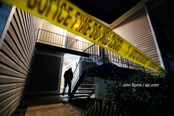 Crime scene tape blocks the breezeway at an apartment complex on Fairburn Road where a 19-year-old man was shot and killed Friday morning.