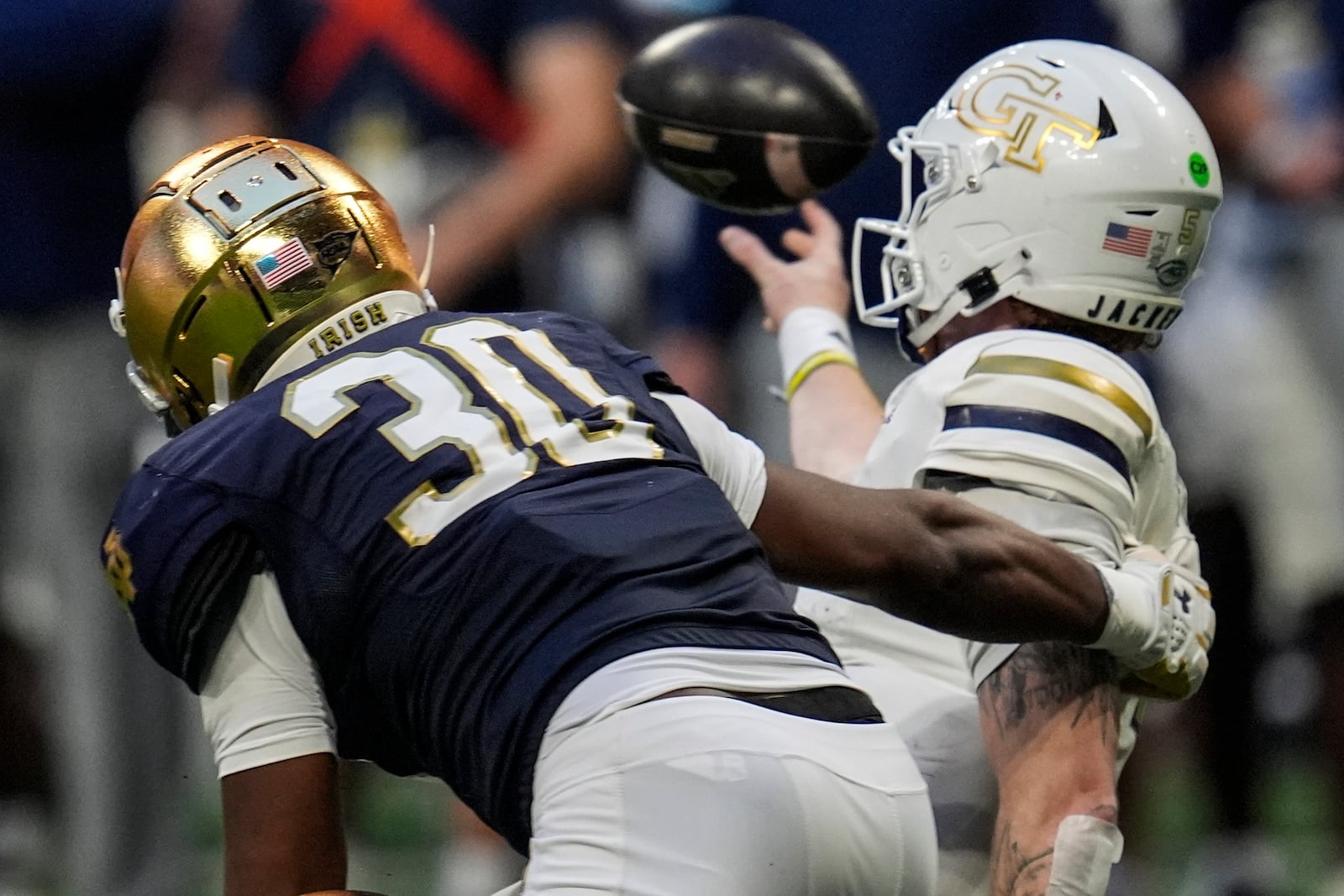 Notre Dame Bryce Young (30) hits Georgia Tech quarterback Zach Pyron (5) during the first half of an NCAA college football game, Saturday, Oct. 19, 2024, in Atlanta. (AP Photo/Mike Stewart)