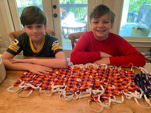 Walker School students Jack, left, and Henry Foster helped their family sew face masks for healthcare workers.