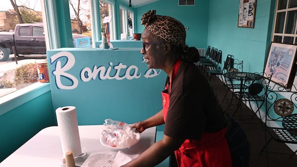 Bonita Hightower, owner of Bonita’s Carry-Out, cleans up a table at Bonita’s Carry-Out in Plains.  Hyosub Shin/AJC