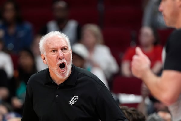 FILE - San Antonio Spurs coach Gregg Popovich, left, yells at official Josh Tiven for not calling a foul during the second half of an NBA basketball game against the Houston Rockets Tuesday, March 5, 2024, in Houston. (AP Photo/David J. Phillip, File)