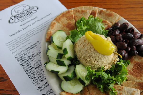 Hummus with cucumbers, olives and pita bread. (BECKY STEIN PHOTOGRAPHY)