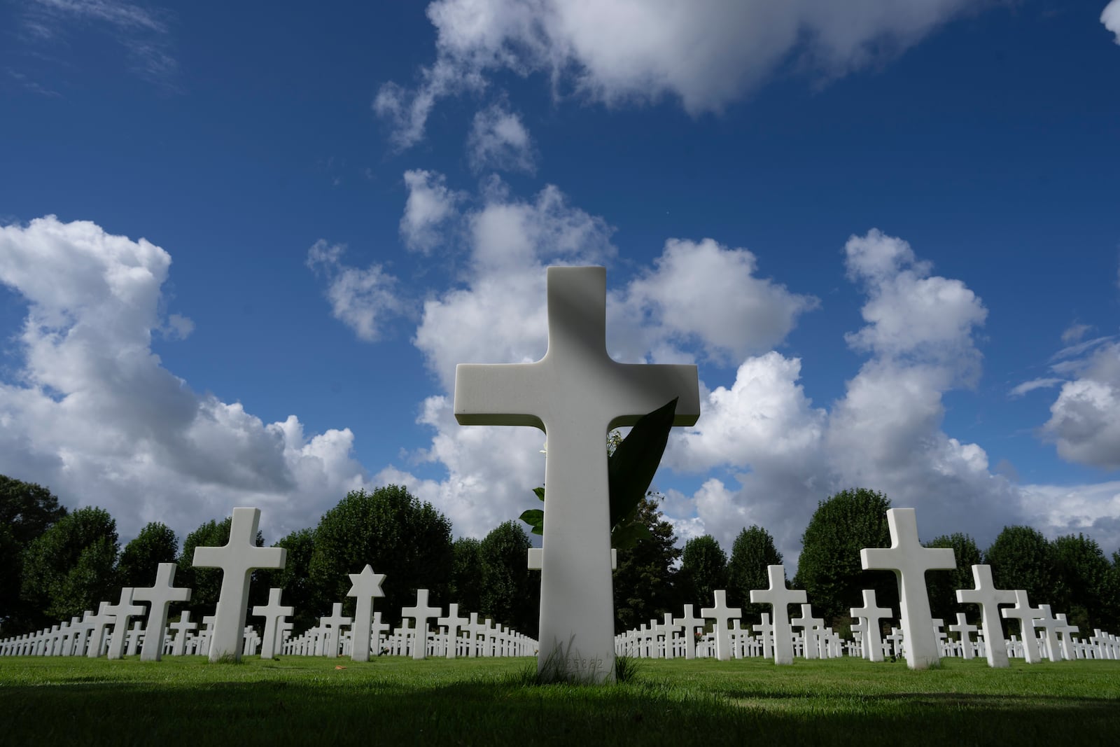 Eighty years after the liberation of the south of the Netherlands the grave of Second Lt. Royce Taylor, a bombardier with the 527 Bomb Squadron, center, stands among the 8,288 crosses and Star of David headstones at the Netherlands American Cemetery in Margraten, southern Netherlands, on Wednesday, Sept. 11, 2024. (AP Photo/Peter Dejong)