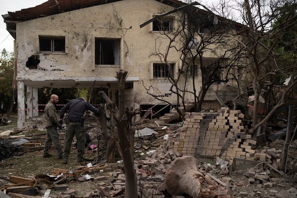 Members of the Israeli forces inspect a site following a rocket fired from Lebanon hit an area in Rinatya, outskirts of Tel Aviv, Israel, Sunday, Nov. 24, 2024. (AP Photo/Leo Correa)