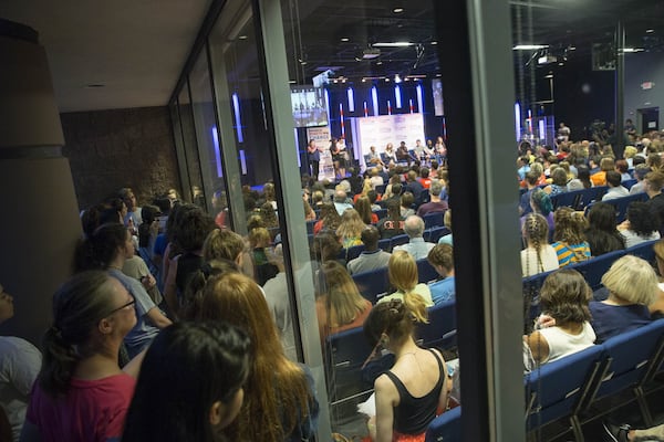 Overflow guests had to stand outside and peer through a window during a March For Our Lives rally at Eagles Nest Church in Roswell, Monday, July 30, 2018. A speaker was brought outside so they could follow along with the panelist during the rally. (ALYSSA POINTER/ALYSSA.POINTER@AJC.COM)