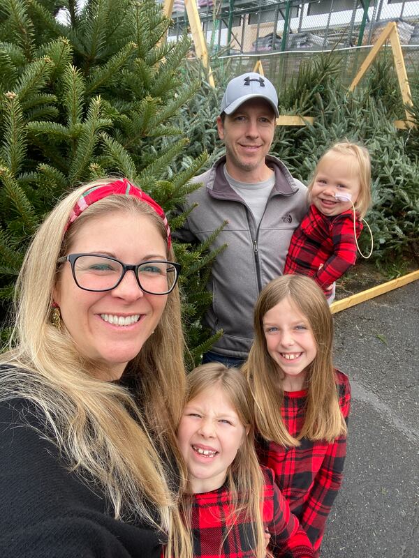 Emmie joined her family recently to pick out a Christmas tree. From left, Mother Andi, Ella (7 years old), Eva (9), and father Ryan holding Emmie. The family says that this Christmas, they will take nothing for granted. (Contributed) 