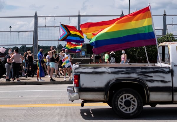 A truck with Pride flags drives past the beginning of the Beauty In Colors Rally and march Sunday afternoon June 28, 2020 in Midtown Atlanta to commemorate the 51st anniversary of the Stonewall riots. (Photo: Ben Gray for The Atlanta Journal-Constitution)