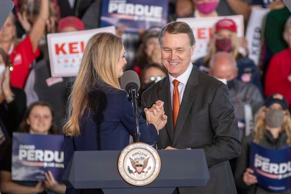 U.S. Sens. Kelly Loeffler (left) and David Perdue (right) embrace after speaking to a crowd at a rally in Gainesville, Georgia, on Nov. 20, 2020. Loeffler and Perdue both lost their 2020 races but were nominated this month by President-elect Donald Trump for posts within his administration. (Alyssa Pointer/Atlanta Journal-Constitution/TNS)