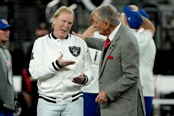 Las Vegas Raiders owner Mark Davis, left, talks with Atlanta Falcons owner Arthur Blank prior to an NFL football game, Monday, Dec. 16, 2024, in Las Vegas. (AP Photo/Rick Scuteri)