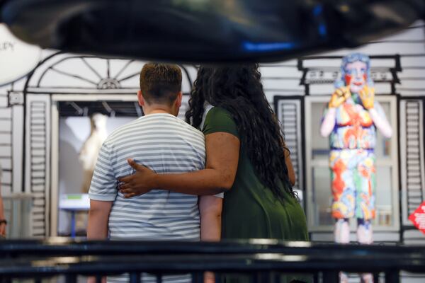 Dylan Sugg stands next to his new Applied Behavioral Analysis therapist, Danielle Daniels, at The Museum of Arts and Sciences in Macon, Ga. on Wednesday, July 11, 2023. Along with Dylan's parents, Danielle accompanies Dylan to the museum and helps him engage with the space. (Natrice Miller/natrice.miller@ajc.com)