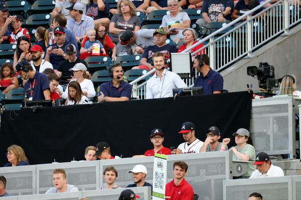 Braves broadcasters Chip Caray, center left, and Jeff Francoeur, center right, interview Braves pitcher Mike Soroka, center, as they broadcast from the right field stands on May 27, 2022.  (Jason Getz / Jason.Getz@ajc.com)