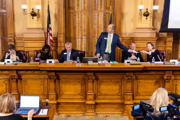 State Election Board member Sara Tindall Ghazal (from left), member Janelle King, Executive Director Mike Coan, Chairman John Fervier, member Rick Jeffares and member Janice Johnston get ready before the State Election Board meeting in Atlanta on Monday, Sept. 23, 2024. (Arvin Temkar/AJC)